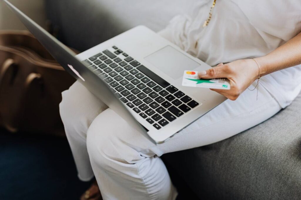 A woman checking her Global Investment Bank and Capital Trustlogin details